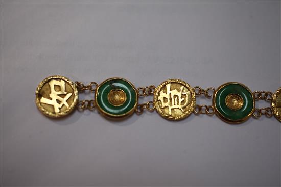 A Chinese gold and jadeite disc link bracelet, 6.75in.